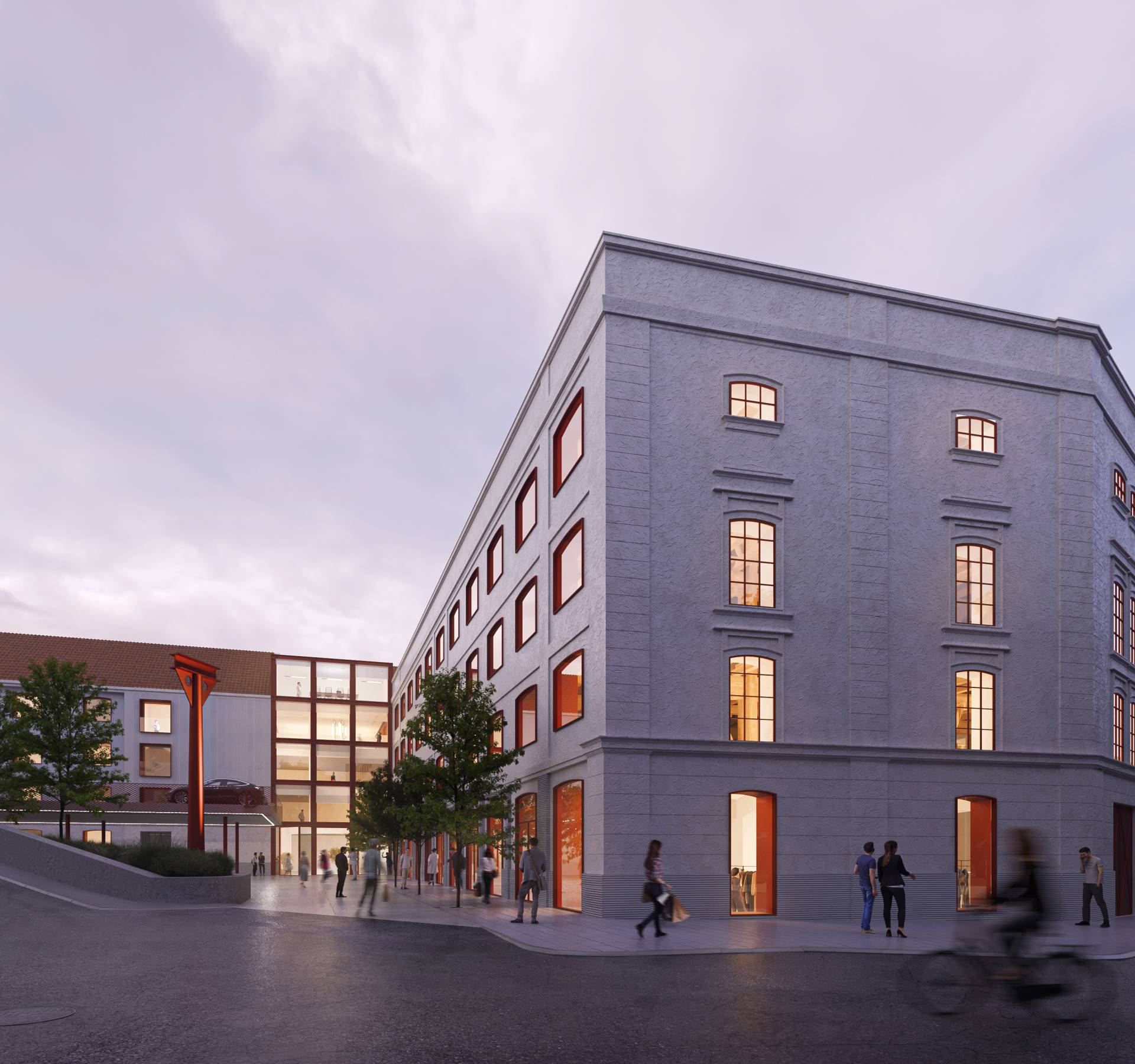 A modern building with large windows at a street corner during dusk, with people walking around the building